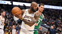 Los Angeles Lakers forward LeBron James (23) grabs a rebound in front of Dallas Mavericks forward Dwight Powell (7) during the first quarter at the American Airlines Center.