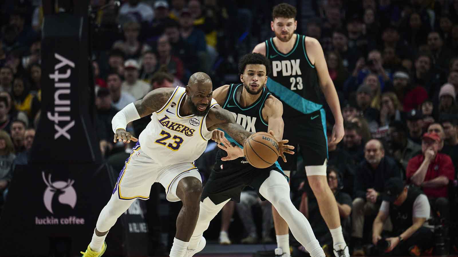 Los Angeles Lakers forward LeBron James (23) is fouled during the first half by Portland Trail Blazers forward Toumani Camara (33) at Moda Center.