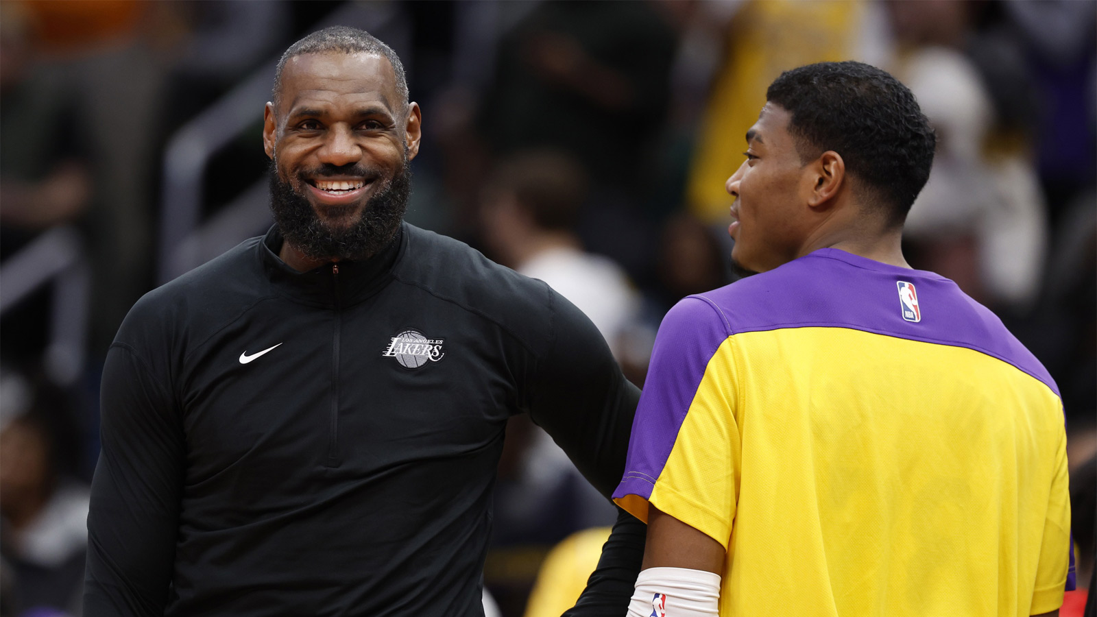 Los Angeles Lakers forward LeBron James (L) and Lakers forward Rui Hachimura (R) joke on the bench against the Washington Wizards in the third quarter at Capital One Arena. 