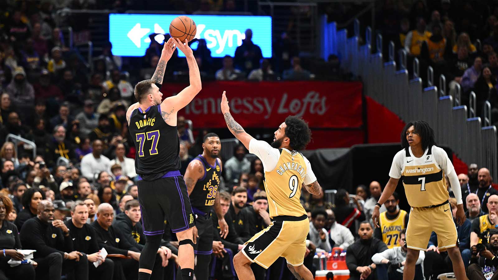 Los Angeles Lakers forward/guard Luka Doncic (77) shoots over Washington Wizards guard/forward Justin Champagnie (9) during the first half at Capital One Arena.