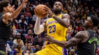 Los Angeles Lakers forward LeBron James (23) shoots a jump shot against New Orleans Pelicans forward Zion Williamson (1) during the first half at Smoothie King Center.