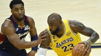 Cleveland Cavaliers guard Donovan Mitchell (45) defends Los Angeles Lakers forward LeBron James (23) in the fourth quarter at Rocket Arena.