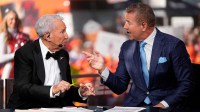 Lee Corso, middle, talks to Kirk Herbstreit on the set of ESPN College GameDay for his final show prior to the NCAA football game between the Ohio State Buckeyes and the Texas Longhorns at Ohio Stadium on Aug. 30, 2025.