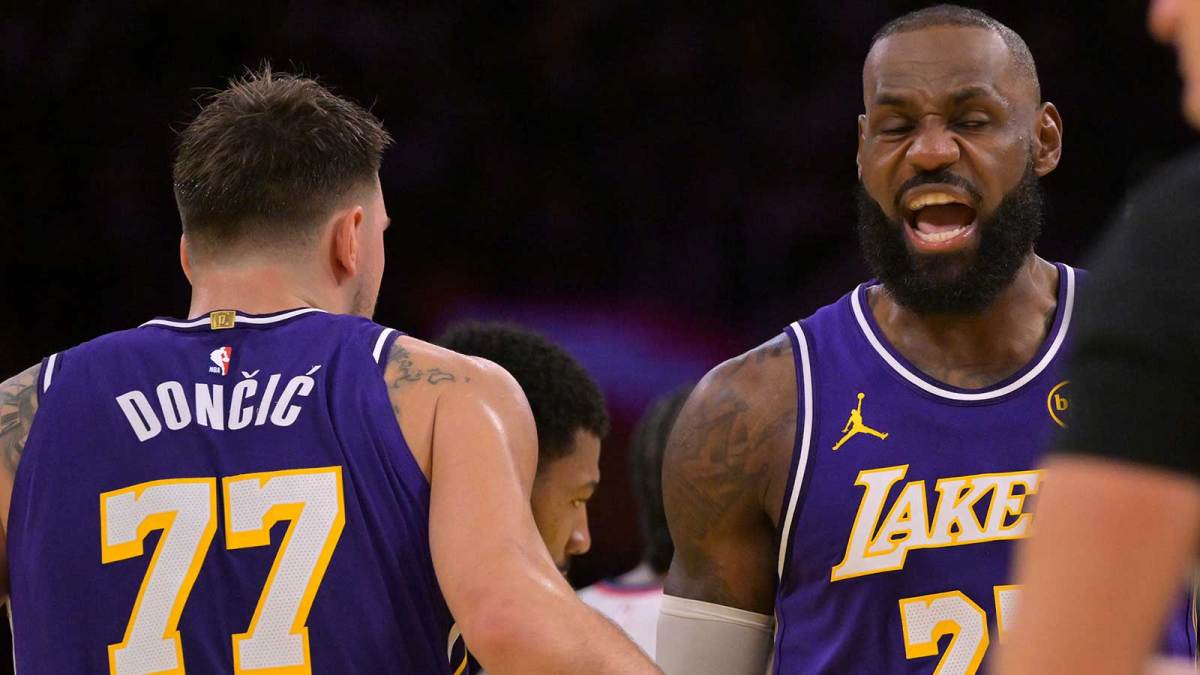 Los Angeles Lakers guard Luka Doncic (77) and forward LeBron James (23) react after a foul during the first half against the Los Angeles Clippers at Crypto.com Arena.