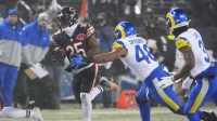 Chicago Bears running back Kyle Monangai (25) runs with the ball against Los Angeles Rams linebacker Omar Speights (48) and safety Kam Curl (3) during the second quarter of an NFC Divisional Round game at Soldier Field. Mandatory Credit: David Banks-Imagn Images
