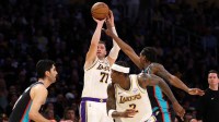Los Angeles Lakers forward/guard Luka Doncic (77) shoots the ball over Memphis Grizzlies forward GG Jackson (45) during the first quarter at Crypto.com Arena.