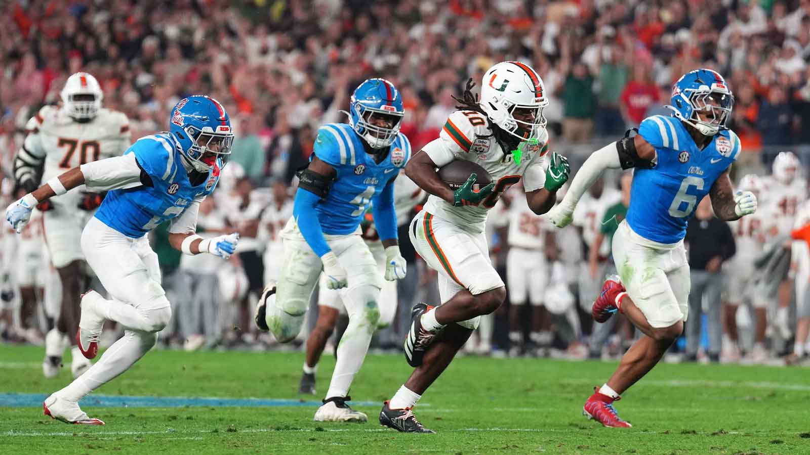Miami Hurricanes wide receiver Malachi Toney (10) makes a catch for a touchdown against the Mississippi Rebels in the second half during the 2026 Fiesta Bowl and semifinal game of the College Football Playoff at State Farm Stadium.