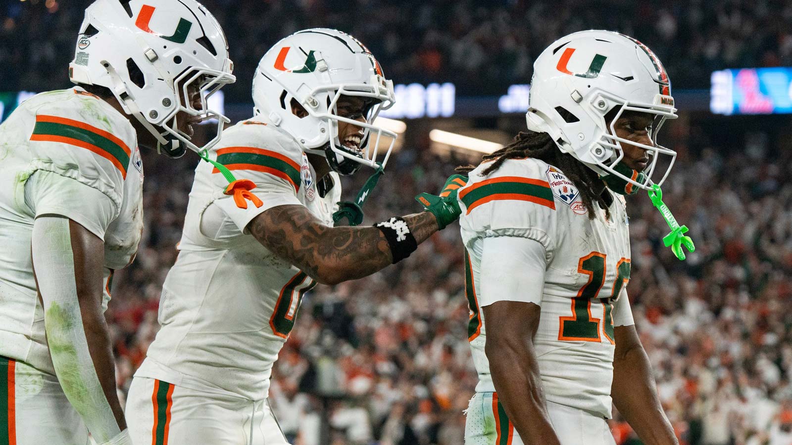Miami Hurricanes wide receiver Keelan Marion (0) pats Malachi Toney (10) on the back after his touchdown during the CFP Fiesta Bowl at the State Farm Stadium, in Glendale, Ariz., on Thursday, Jan. 8, 2026.