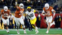 Texas Longhorns quarterback Arch Manning (16) rushes with the ball for a touchdown against the Michigan Wolverines during the second half at Camping World Stadium