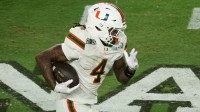 Miami Hurricanes running back Mark Fletcher Jr. (4) carries the ball against the Indiana Hoosiers in the third quarter during the College Football Playoff National Championship game at Hard Rock Stadium.