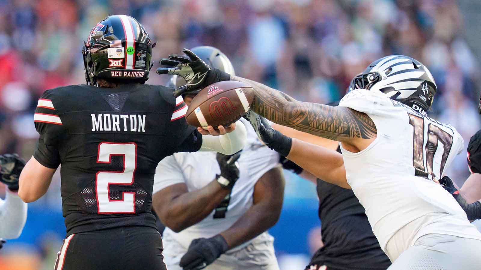 Oregon outside linebacker Matayo Uiagalelei, right, strips the ball from Texas Tech quarterback Behren Morton as the Oregon Ducks take on the Texas Tech Red Raiders in the Orange Bowl on Jan. 1, 2026, at Hard Rock Stadium in Miami, Florida.