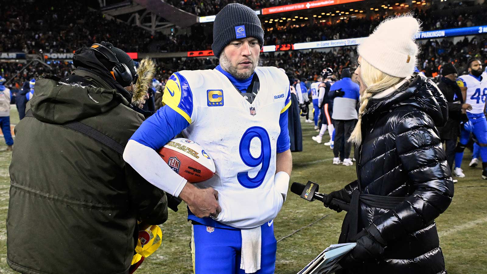 Los Angeles Rams quarterback Matthew Stafford (9) holds a game ball as he is interviewed by NBC sideline reporter Melissa Stark after a NFC Divisional Round game against the Chicago Bears at Soldier Field.