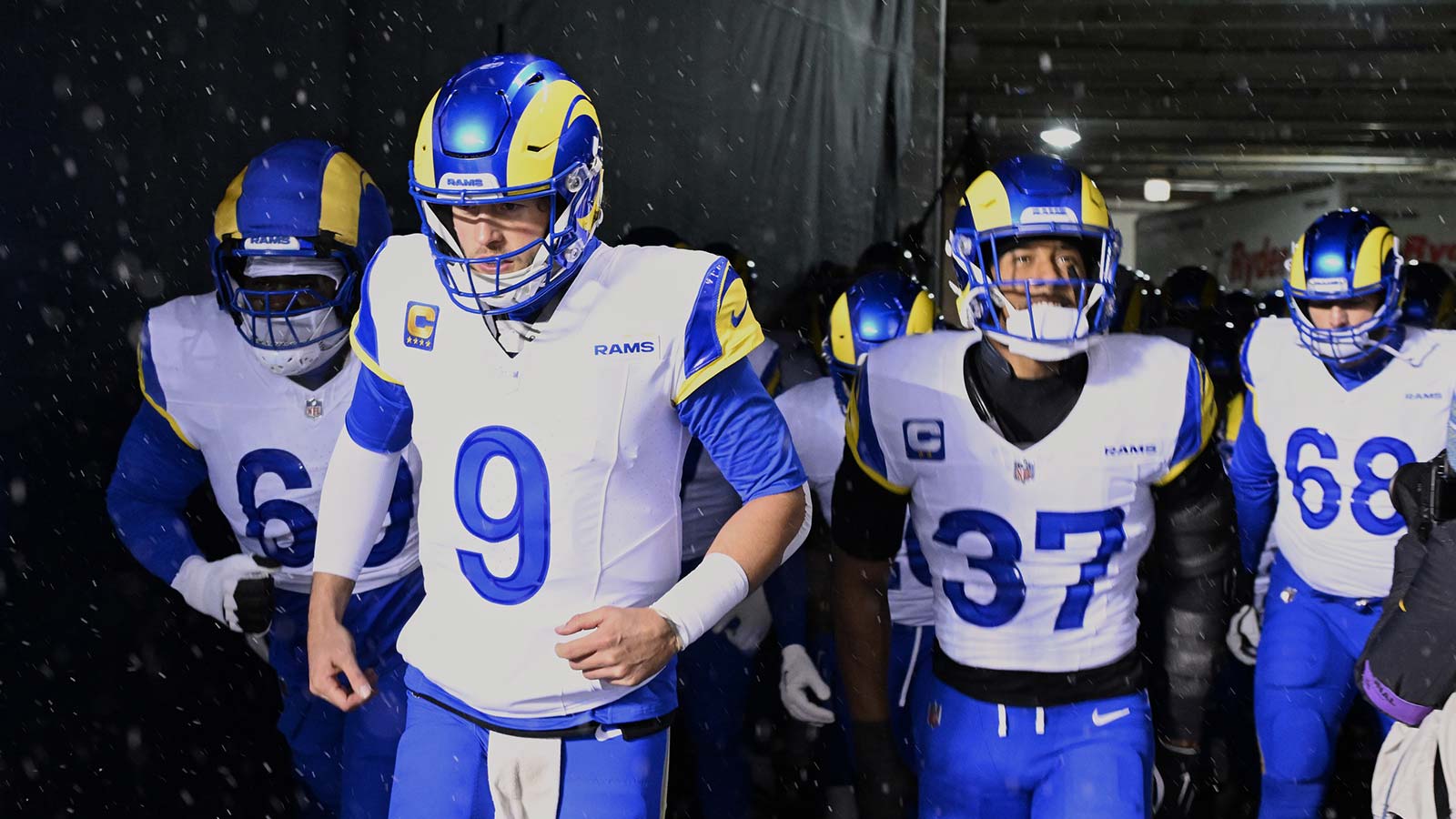 Los Angeles Rams quarterback Matthew Stafford (9), guard Kevin Dotson (69), safety Quentin Lake (37) and offensive tackle David Quessenberry (68) run onto the field before an NFC Divisional Round game against the Chicago Bears at Soldier Field.