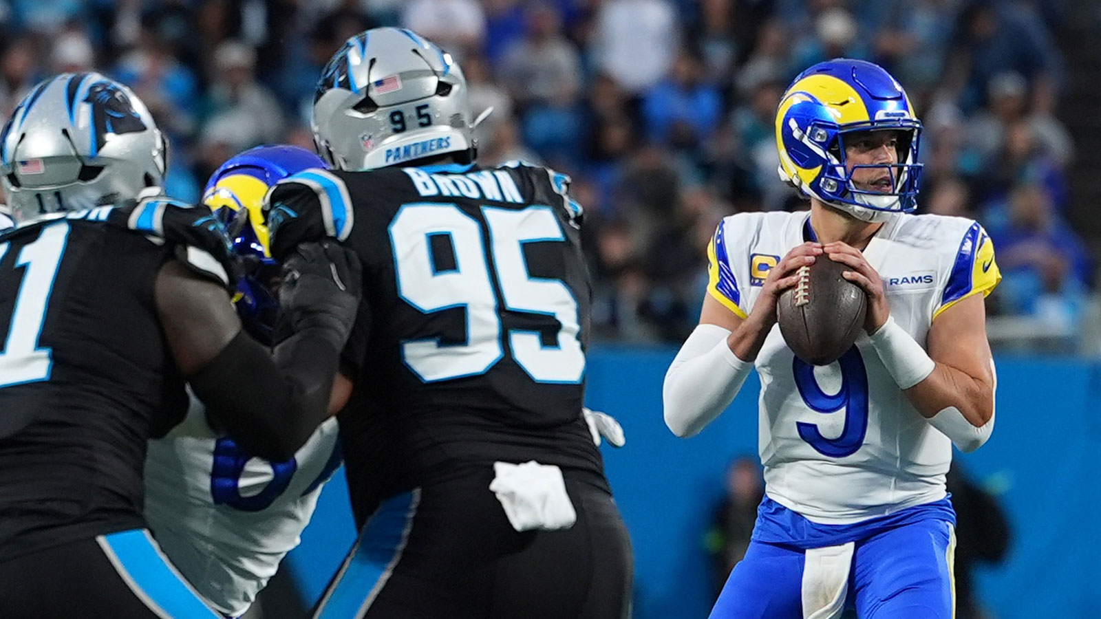 Los Angeles Rams quarterback Matthew Stafford (9) drops back to pass against the Carolina Panthers in the first half during the NFC Wild Card Round game at Bank of America Stadium.