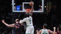 Boston Celtics guard Jaylen Brown (7) makes the basket against Toronto Raptors forward Sandro Mamukelashvili (54) in the second half at TD Garden.