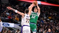 Dallas Mavericks forward Cooper Flagg (32) makes a jump shot over Los Angeles Lakers guard Luka Doncic (77) during the first quarter at the American Airlines Center.