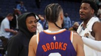 Memphis Grizzlies guard Ja Morant (left) and forward Jaren Jackson Jr. (right) talk with Phoenix Suns forward Dillon Brooks (3) after the game at FedExForum.
