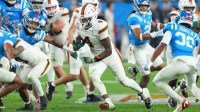 Miami Hurricanes running back Mark Fletcher Jr. (4) rushes the ball against the Mississippi Rebels in the second half during the 2026 Fiesta Bowl and semifinal game of the College Football Playoff at State Farm Stadium.