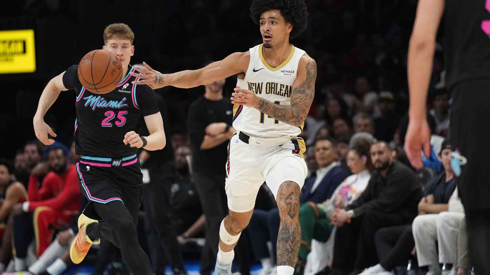 New Orleans Pelicans guard Micah Peavy (14) passes the ball as Miami Heat guard Kasparas Jakucionis (25) follows on the play during the second half at Kaseya Center.