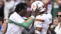 Former Miami Hurricanes player Michael Irvin celebrates with Miami Hurricanes defensive back Jakobe Thomas (8) after an interception against the Texas A&M Aggies during the second half of the first round game of the CFP National Playoff at Kyle Field.