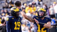 Michigan quarterback Jake Garcia (12) warms up ahead of the Washington game at Michigan Stadium in Ann Arbor