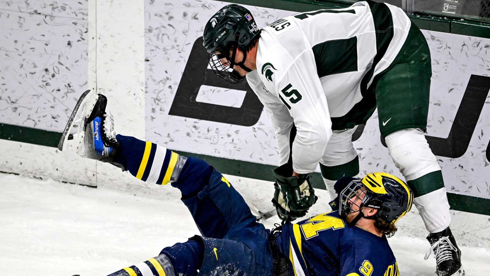 Michigan State's Charlie Stramel, top, pushes down Michigan's Nick Moldenhauer while trying to gain control of the puck during the first period on Friday, Dec. 5, 2025, at Munn Ice Arena in East Lansing.