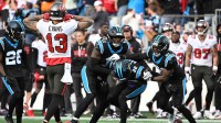 Carolina Panthers safety Lathan Ransom (22) celebrates with linebacker Nic Scourton (11) and safety Nick Scott (21) after intercepting the ball to seal the victory in the fourth quarter as Tampa Bay Buccaneers wide receiver Mike Evans (13) reacts at Bank of America Stadium