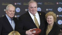 Joe McCarthy Jr. (left) and Ellen McCarthy (right) flank their son Mike McCarthy (middle) at a press conference announcing Mike as the new Pittsburgh Steelers head coach at PNC Champions Club at Acrisure Stadium..