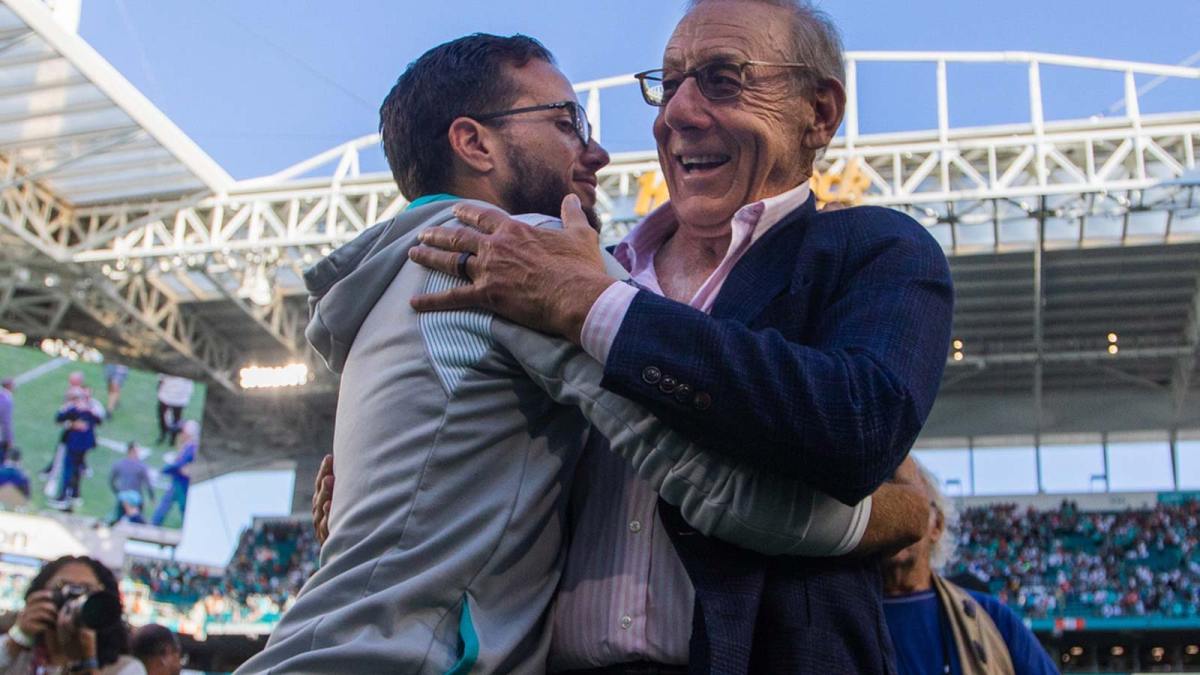 Miami Dolphins head coach Mike McDaniel embraces Dolphins owner Stephen Ross after the Dolphins beat the New York Jets at Hard Rock Stadium on Sunday, January 8, 2023, in Miami Gardens, FL.