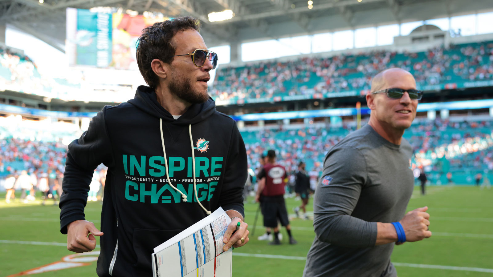Miami Dolphins head coach Mike McDaniel runs off the field following a win over the Tampa Bay Buccaneers at Hard Rock Stadium.