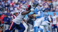 New England Patriots defensive end Milton Williams (97) sacks Tennessee Titans quarterback Cam Ward (1) during the third quarter
