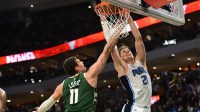 Orlando Magic center Moe Wagner (21) scores a basket against Milwaukee Bucks center Brook Lopez (11)in the fourth quarter at Fiserv Forum.