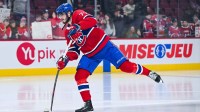 Montreal Canadiens center Kirby Dach (77) shoots a puck during warm-up before the game against the Dallas Stars at Bell Centre.