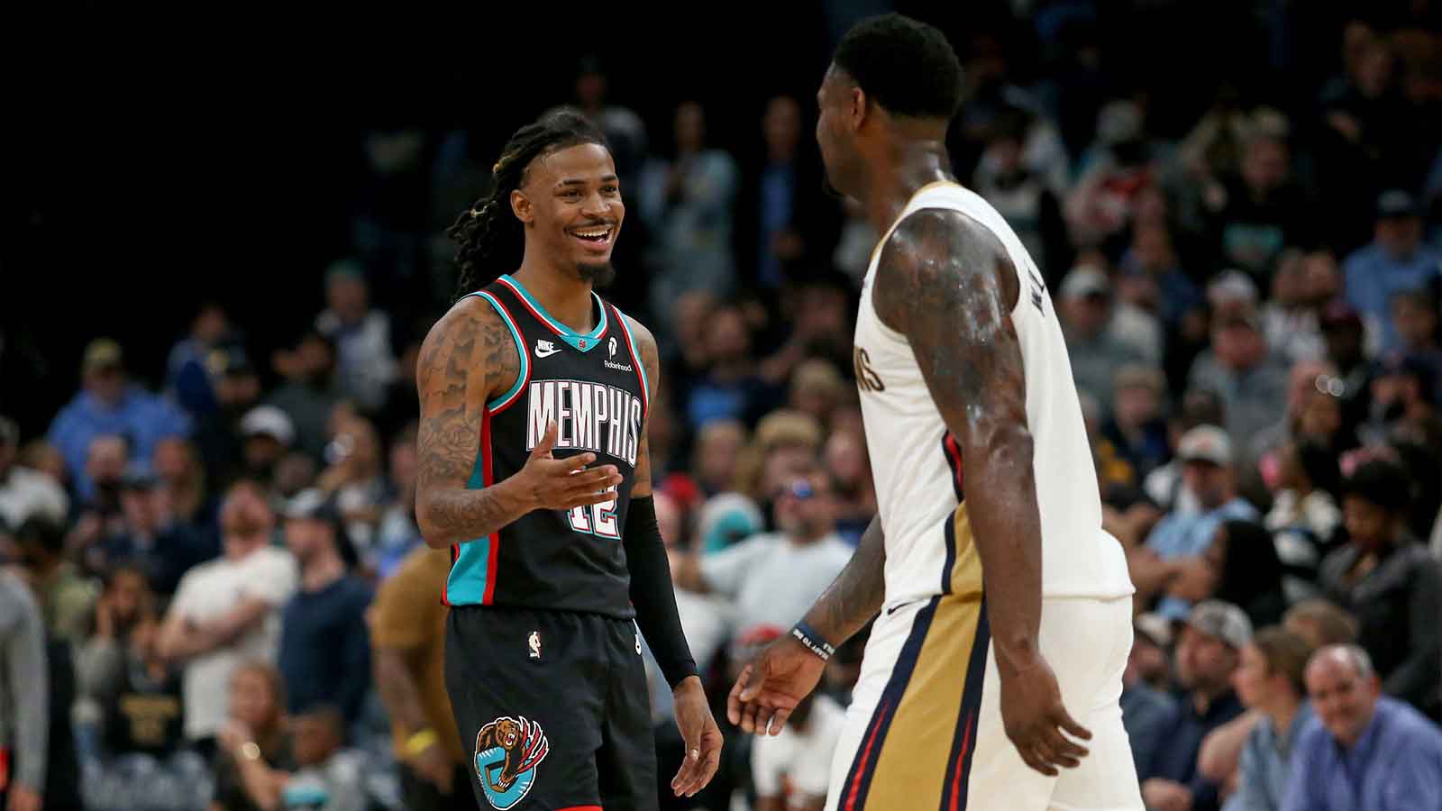 Memphis Grizzlies guard Ja Morant (12) reacts toward New Orleans Pelicans forward Zion Williamson (1) during the fourth quarter at FedExForum.
