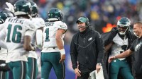 Philadelphia Eagles assistant coach Kevin Patullo celebrates with quarterback Jalen Hurts (1) after a touchdown during the second half against the New York Giants at MetLife Stadium.