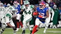 Buffalo Bills running back Ray Davis (22) carries the ball defended by New York Jets safety Keidron Smith (46) and linebacker Jamien Sherwood (44) during the second half at Highmark Stadium.