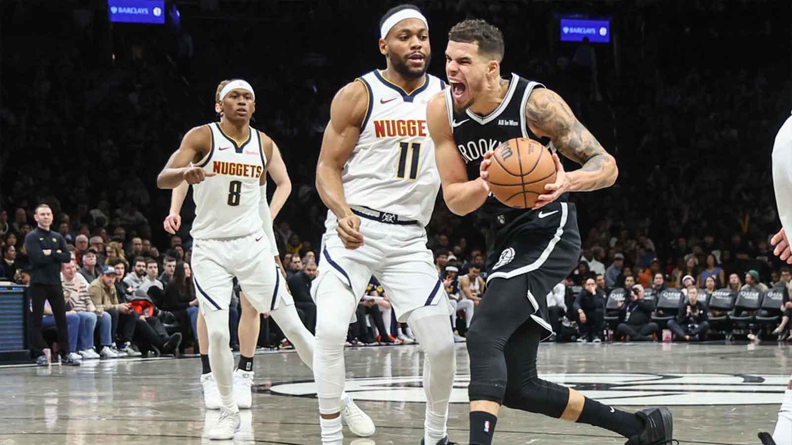 Nets forward Michael Porter Jr. (17) looks to drive past Denver Nuggets guard Bruce Brown (11) in the third quarter at Barclays Center