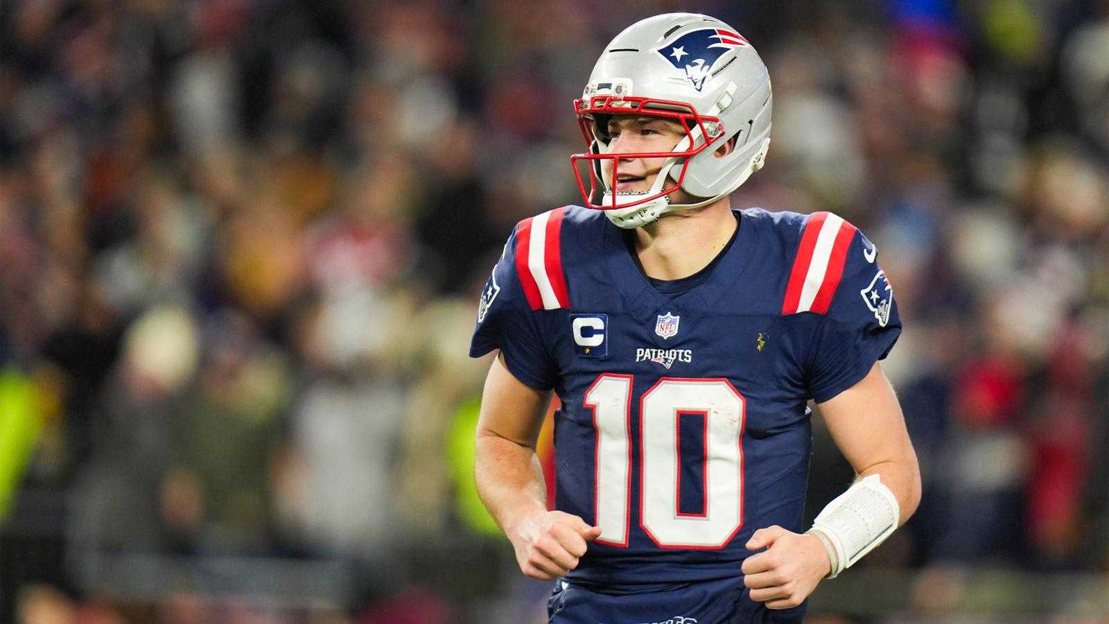 New England Patriots quarterback Drake Maye (10) smiles after a touchdown pass during the fourth quarter against the Los Angeles Chargers in an AFC Wild Card Round game at Gillette Stadium. Mandatory Credit: David Butler II-Imagn Images
