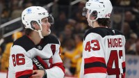 New Jersey Devils center Jack Hughes (86) talks with his brother defenseman Luke Hughes (43) before the start of the third period against the Pittsburgh Penguins at PPG Paints Arena.