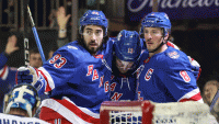 New York Rangers center J.T. Miller (8) celebrates with center Mika Zibanejad (93), and left wing Alexis Lafreniere (13) after scoring a goal in the second period against the Tampa Bay Lightning at Madison Square Garden.