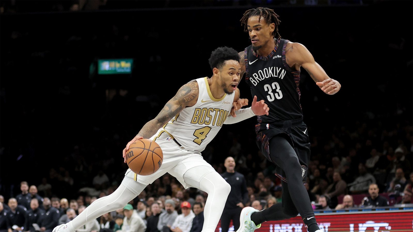 Boston Celtics guard Anfernee Simons (4) controls the ball against Brooklyn Nets center Nic Claxton (33) during the second quarter at Barclays Center.