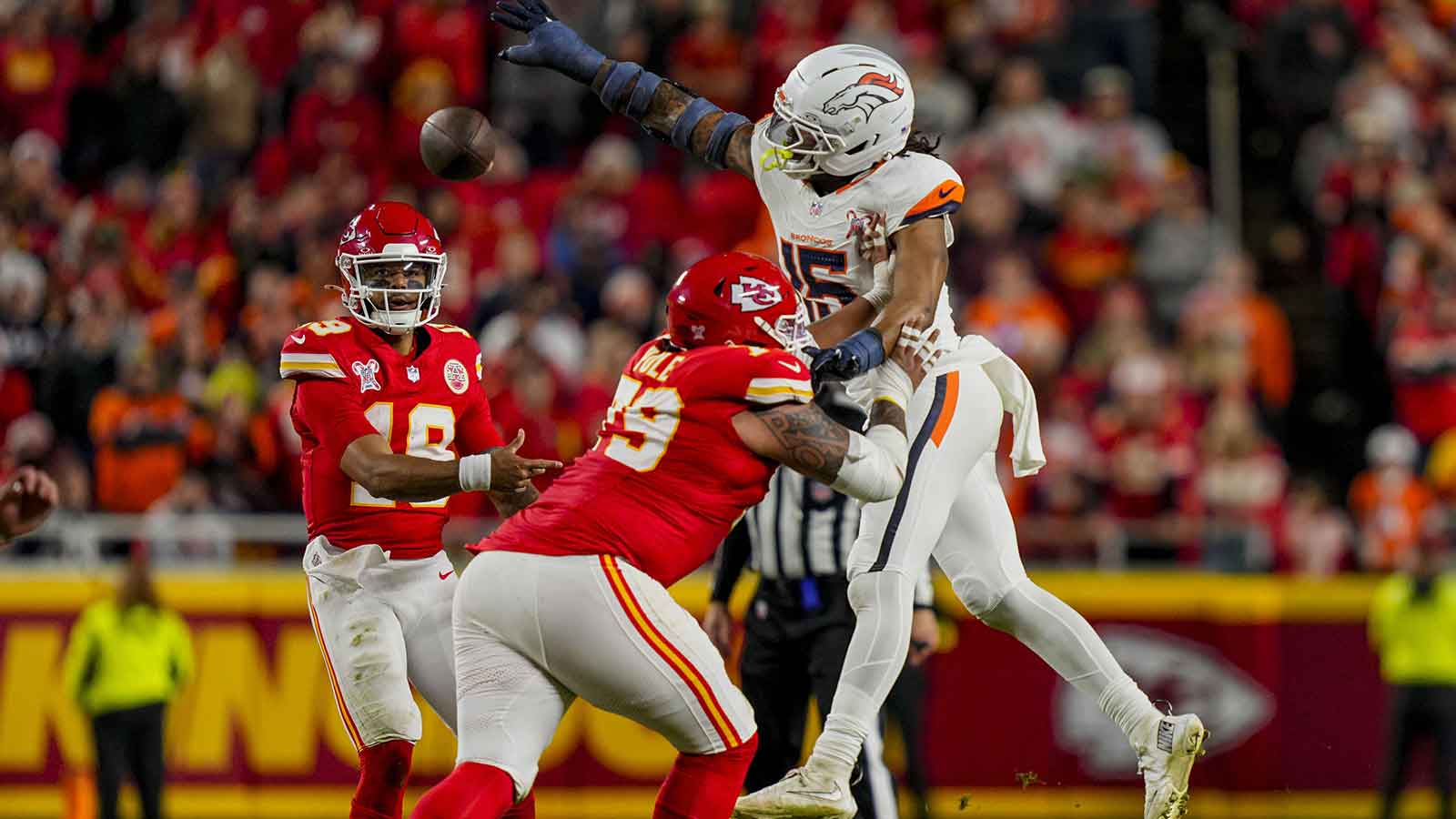 Kansas City Chiefs quarterback Chris Oladokun (19) throws against Denver Broncos linebacker Nik Bonitto (15) during the fourth quarter at GEHA Field at Arrowhead Stadium.
