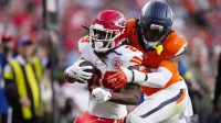Denver Broncos linebacker Nik Bonitto (15) tackles Kansas City Chiefs running back Kareem Hunt (29) carries the ball in the third quarter at Empower Field at Mile High.