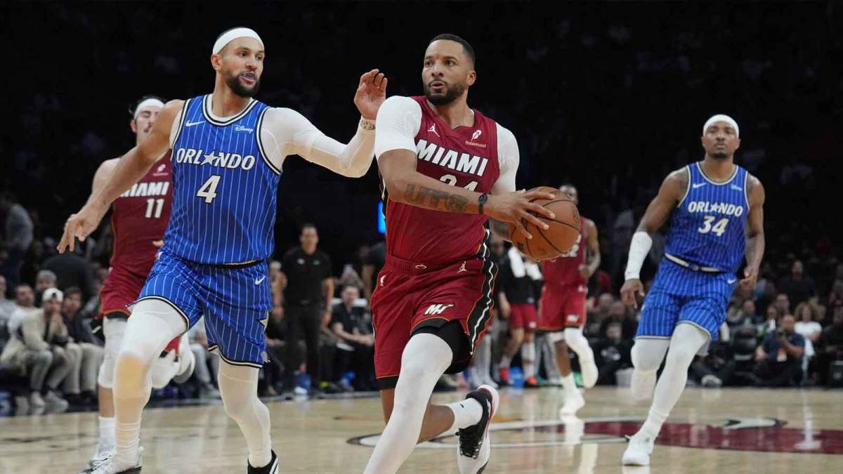 Miami Heat guard Norman Powell (24) drives to the basket as Orlando Magic guard Jalen Suggs (4) follows on the play during the second half at Kaseya Center.