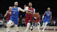 Miami Heat guard Norman Powell (24) drives to the basket as Orlando Magic guard Jalen Suggs (4) follows on the play during the second half at Kaseya Center.