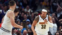 Nuggets forward Aaron Gordon (32) points to Denver Nuggets forward Christian Braun (0) after assisting on a basket during the first half against the Chicago Bulls at Ball Arena