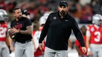 Ohio State Buckeyes head coach Ryan Day leads warm-ups prior to the Cotton Bowl at AT&T Stadium in Arlington, Texas.