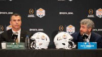 Ole Miss Head Coach Pete Golding looks over at Miami Head Coach Mario Cristobal during a CFP and Fiesta Bowl press conference at the JW Marriott Scottsdale Camelback Inn Resort & Spa, in Scottsdale, Ariz., on Wednesday, Jan. 7, 2026.