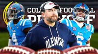 Ole Miss HC Pete Golding (front, center) with Ole Miss QB Trinidad Chambliss and Ole Miss LB Suntarine Perkins behind him. College Football Playoff logo in background