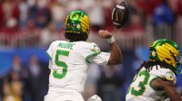Oregon Ducks quarterback Dante Moore (5) fumbles against the Indiana Hoosiers during the first half of the 2025 Peach Bowl and semifinal game of the College Football Playoff at Mercedes-Benz Stadium